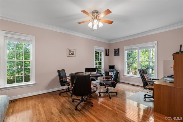 office area with light wood-type flooring, ceiling fan, and crown molding