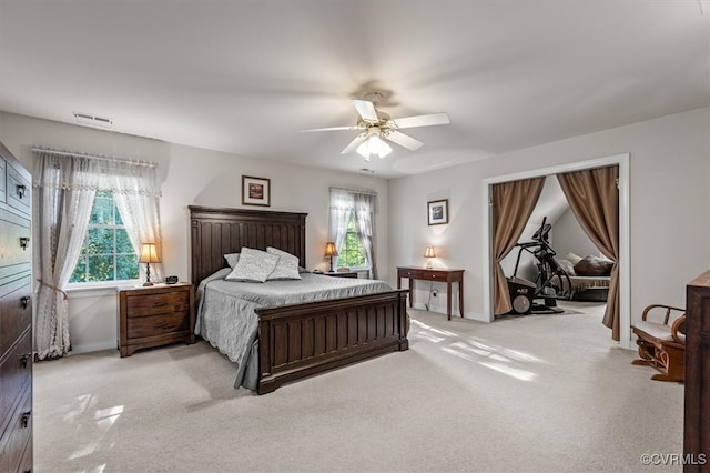 bedroom with ceiling fan and light carpet