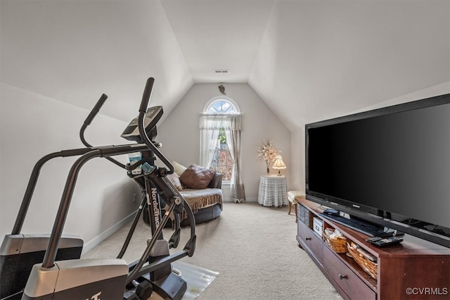 exercise area featuring light colored carpet and lofted ceiling