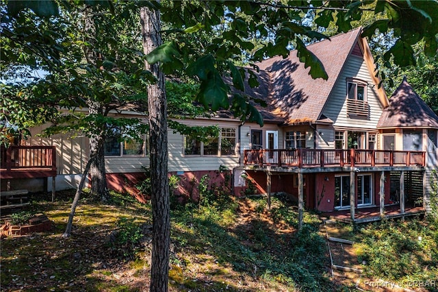 rear view of house with a wooden deck