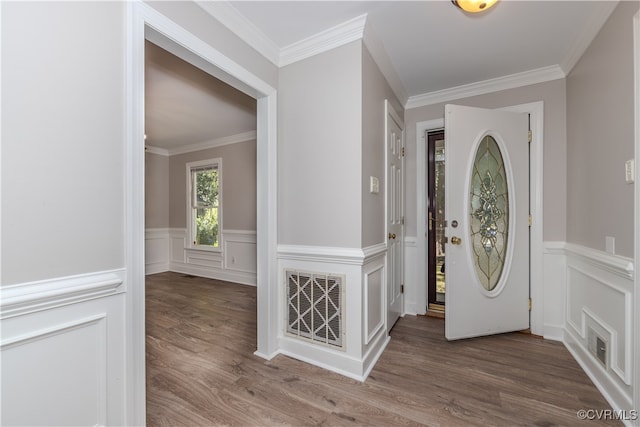 foyer entrance featuring ornamental molding and hardwood / wood-style flooring