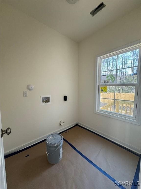 clothes washing area with laundry area, hookup for a washing machine, and baseboards