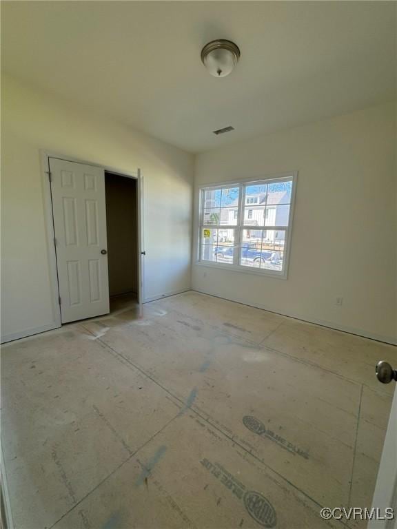 unfurnished room featuring visible vents