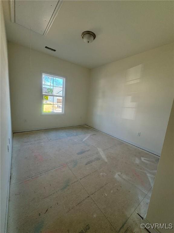 empty room featuring attic access