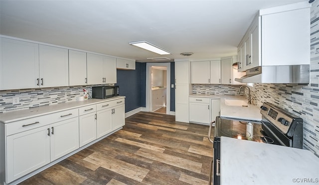 kitchen with white cabinets, stainless steel electric stove, dark hardwood / wood-style floors, and sink