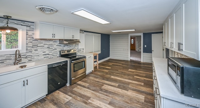 kitchen featuring dark wood-type flooring, white cabinetry, tasteful backsplash, and black appliances