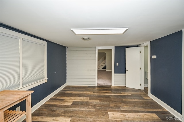 empty room with dark hardwood / wood-style flooring