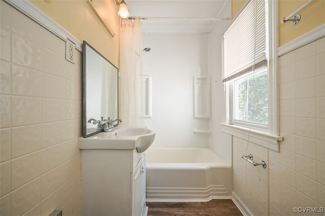 bathroom featuring washtub / shower combination, hardwood / wood-style flooring, and vanity