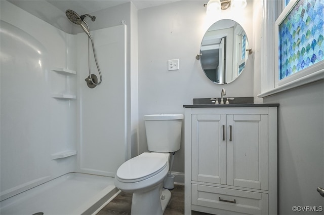 bathroom with vanity, a shower, toilet, and wood-type flooring