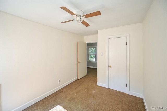 unfurnished bedroom with light colored carpet and ceiling fan