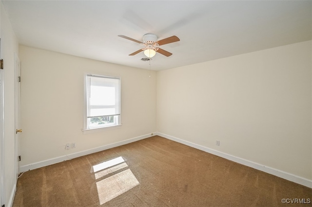 carpeted spare room with ceiling fan