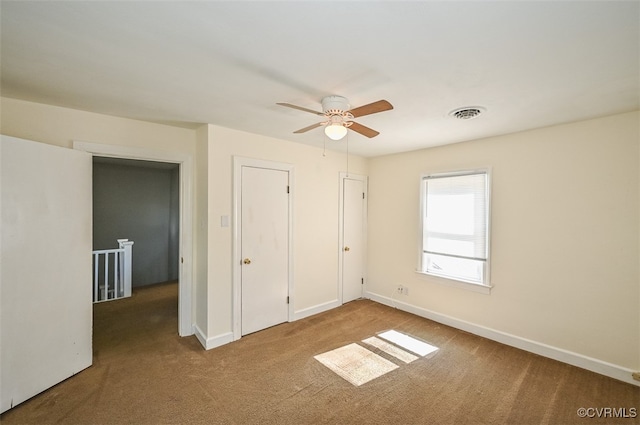 unfurnished bedroom with light colored carpet and ceiling fan