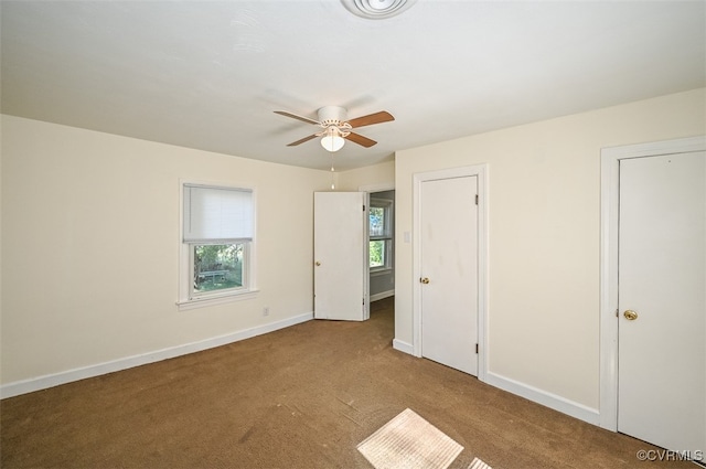 unfurnished bedroom featuring light carpet and ceiling fan