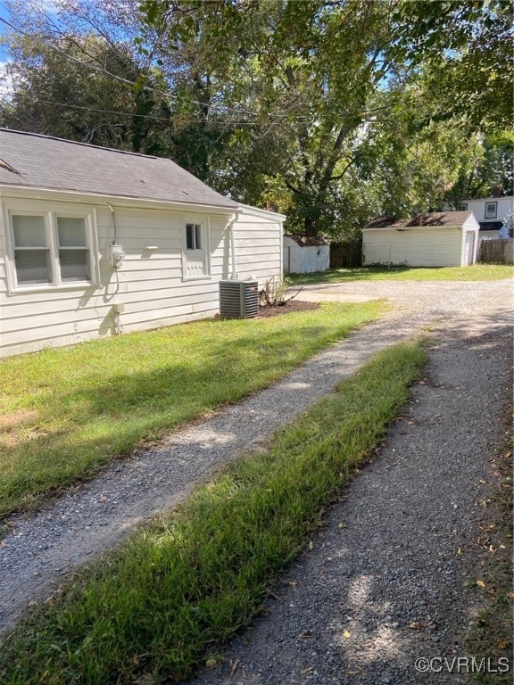 view of yard with a shed and central air condition unit