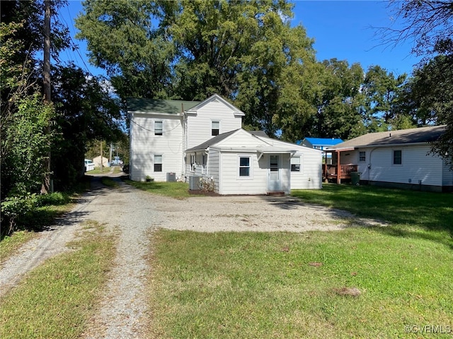 back of house with a yard and central AC