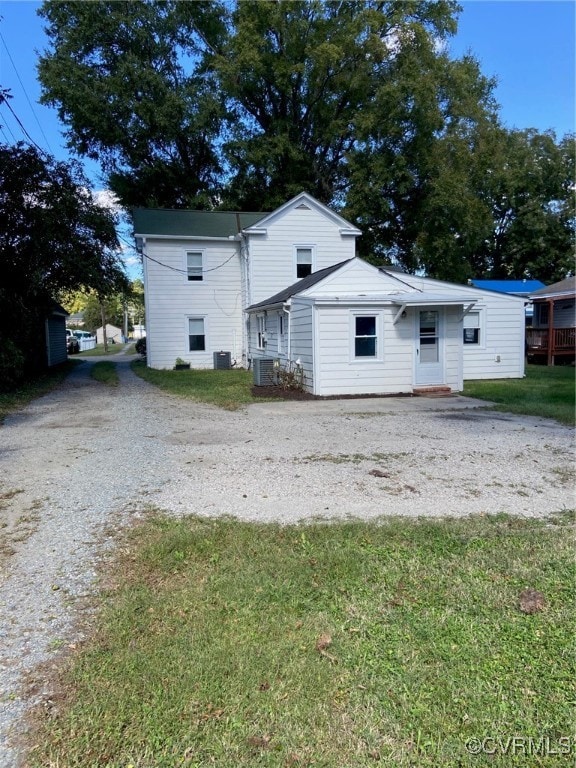 exterior space featuring a yard and central air condition unit