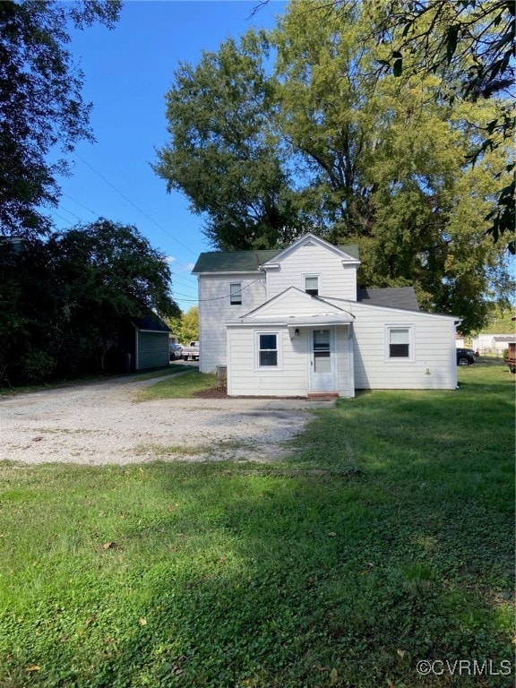 back of property featuring a yard