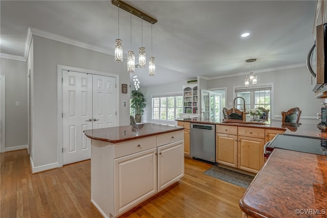 kitchen featuring a center island, sink, light wood-type flooring, appliances with stainless steel finishes, and a chandelier