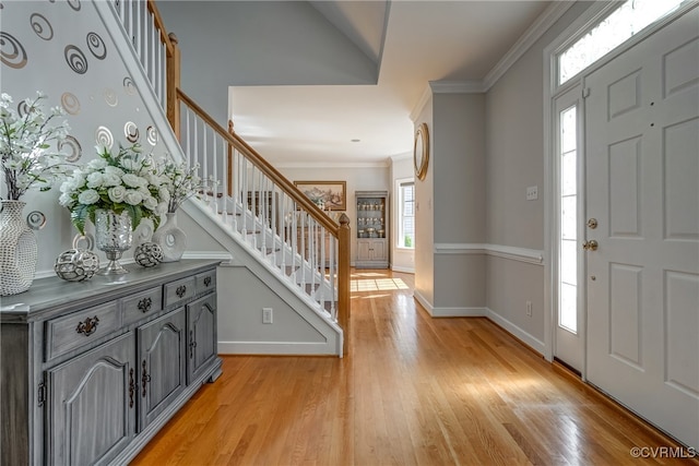 entryway featuring crown molding and light hardwood / wood-style flooring