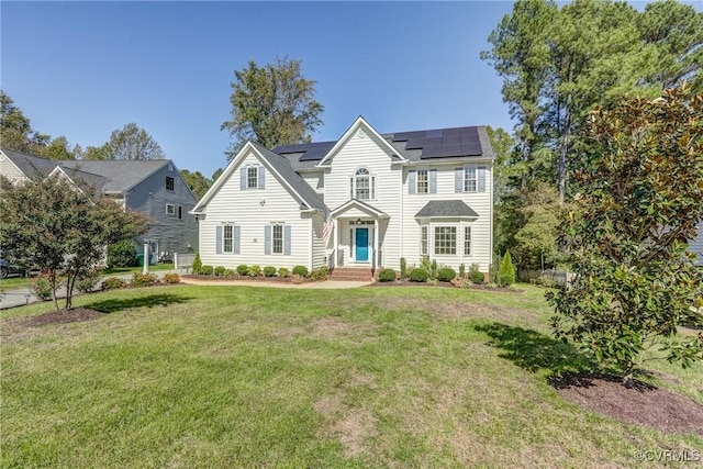 view of front of property with solar panels and a front lawn