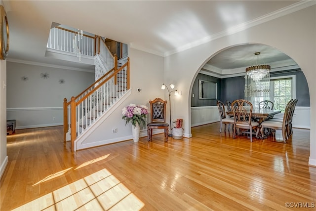 interior space featuring hardwood / wood-style flooring, a notable chandelier, and crown molding