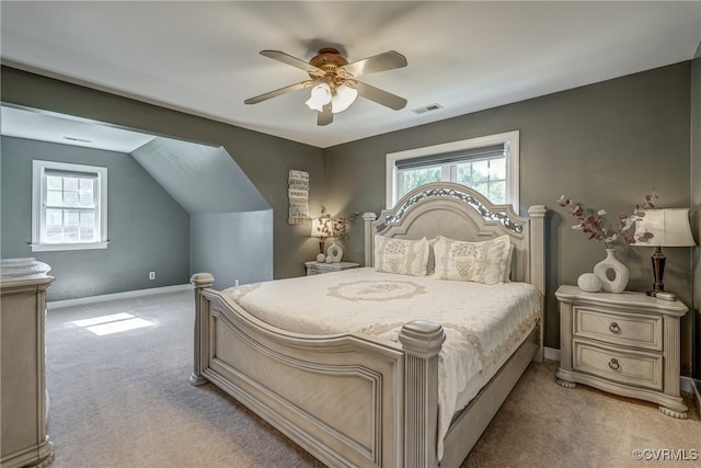 bedroom featuring ceiling fan, light colored carpet, and lofted ceiling