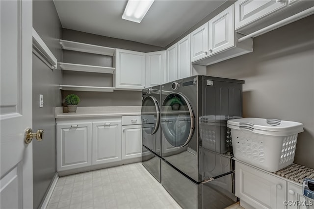 washroom featuring separate washer and dryer and cabinets