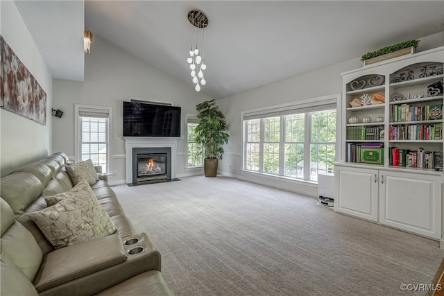 carpeted living room with high vaulted ceiling