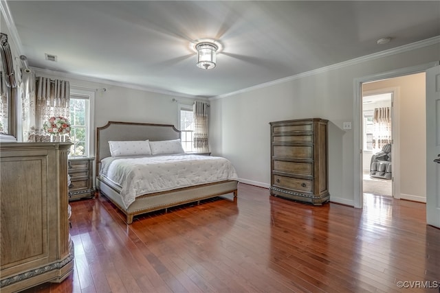 bedroom featuring wood-type flooring, multiple windows, and crown molding