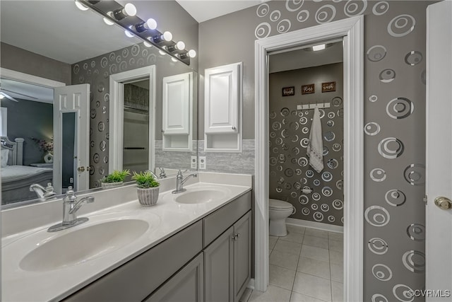 bathroom featuring tile patterned floors, vanity, and toilet