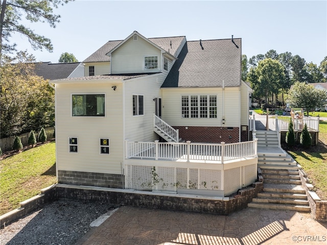 rear view of house featuring a deck