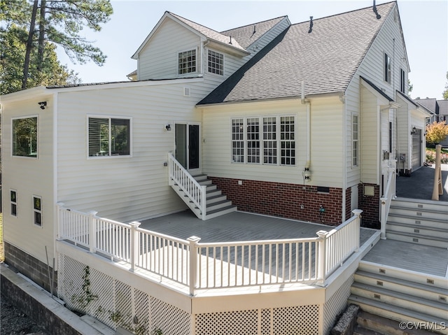 rear view of property featuring a wooden deck