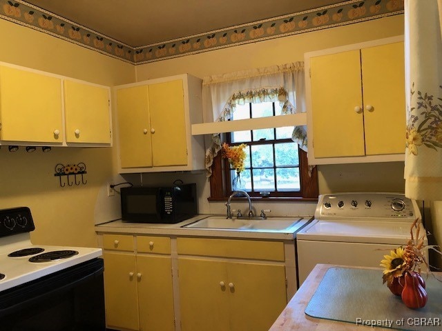 kitchen featuring washer / dryer, sink, and electric stove