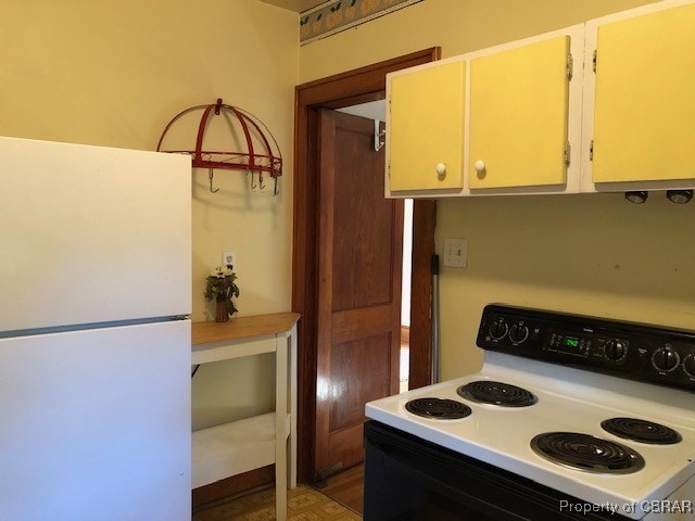 kitchen with white appliances and hardwood / wood-style floors