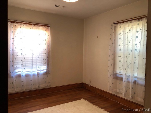 spare room with dark hardwood / wood-style floors