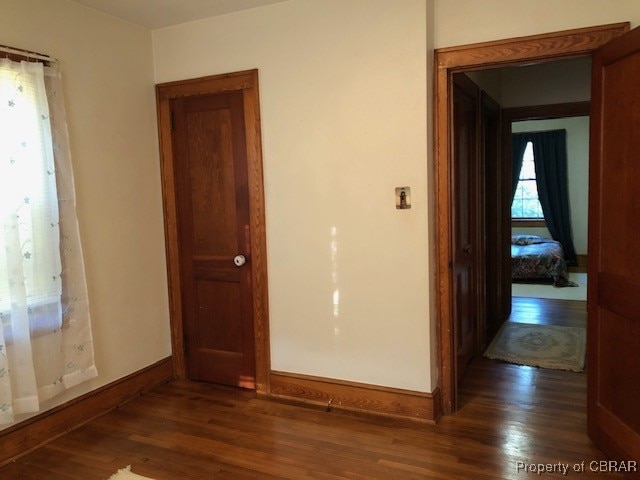 spare room with dark hardwood / wood-style flooring