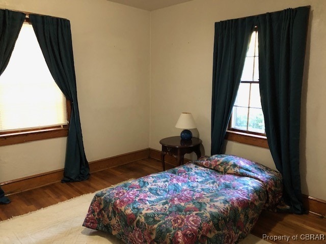 bedroom with hardwood / wood-style flooring