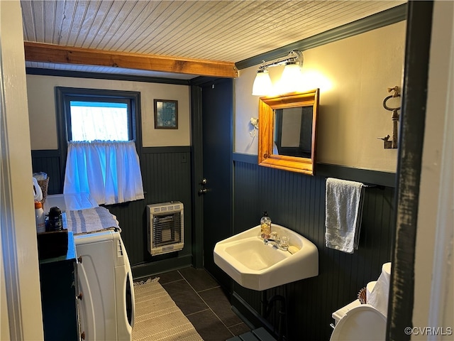 bathroom with beamed ceiling, wood ceiling, heating unit, washer / dryer, and tile patterned flooring