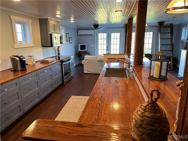 interior space with wood ceiling, sink, dark hardwood / wood-style flooring, crown molding, and a wall mounted AC