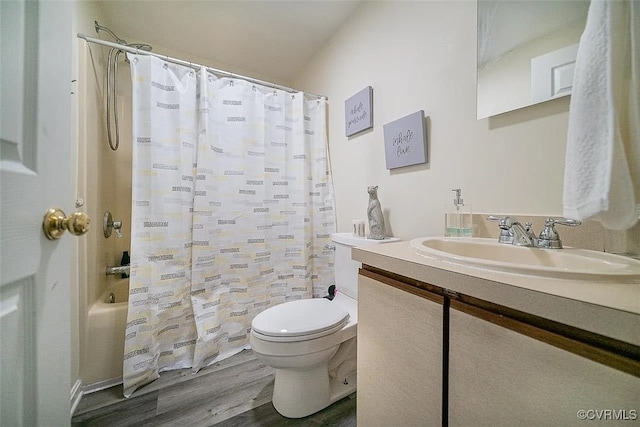 full bathroom featuring hardwood / wood-style flooring, shower / bath combination with curtain, toilet, and vanity