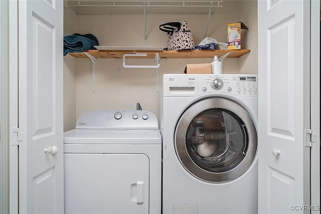 clothes washing area with separate washer and dryer