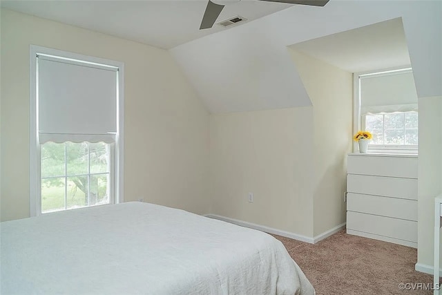 bedroom with ceiling fan, lofted ceiling, light carpet, and multiple windows