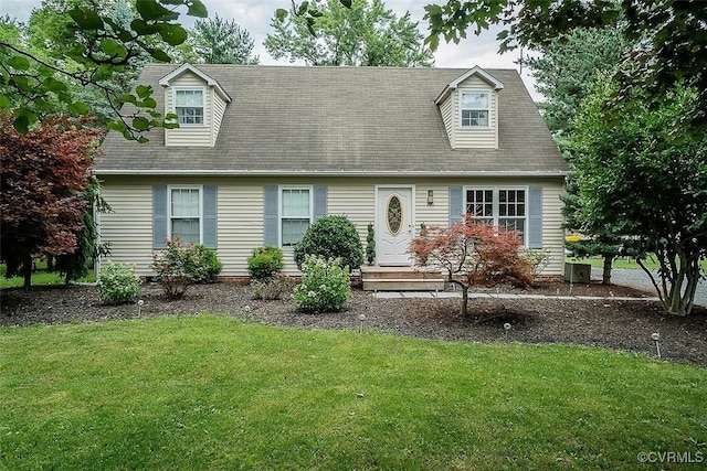 cape cod home with a front lawn