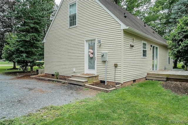 rear view of house with a yard and a deck