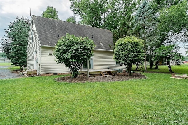 view of home's exterior featuring a deck and a yard