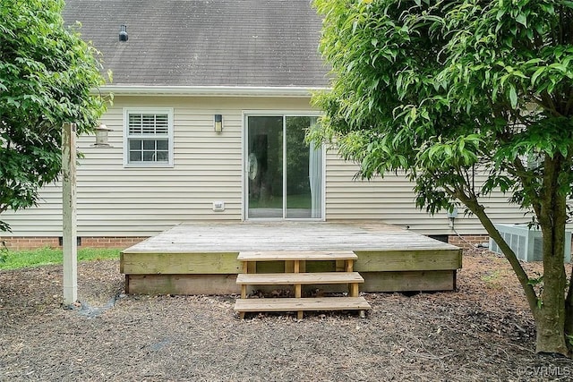 rear view of house with central AC unit and a wooden deck