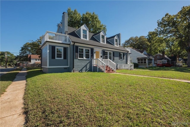 view of front of property with a balcony and a front yard