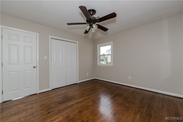 unfurnished bedroom with dark wood-type flooring and ceiling fan