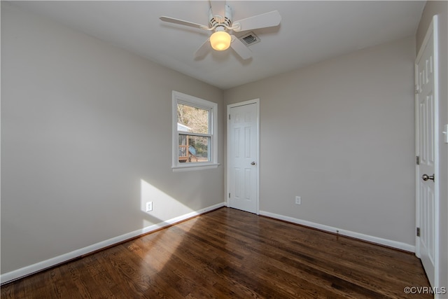 empty room with dark wood-type flooring and ceiling fan