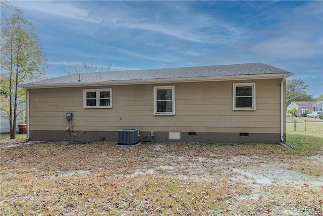 rear view of property featuring central AC unit